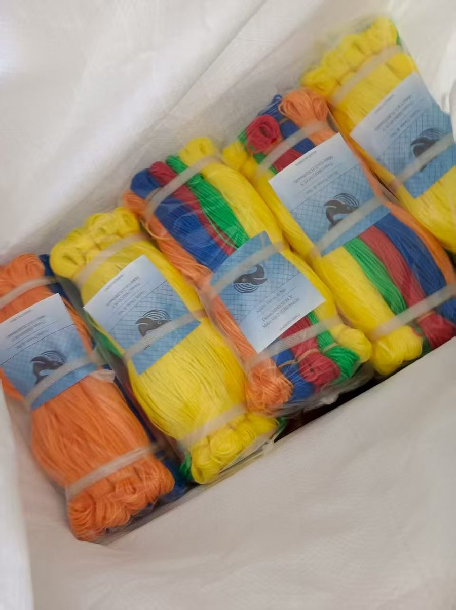 Carton of polybagged rope hanks with printed header cards in assorted colors