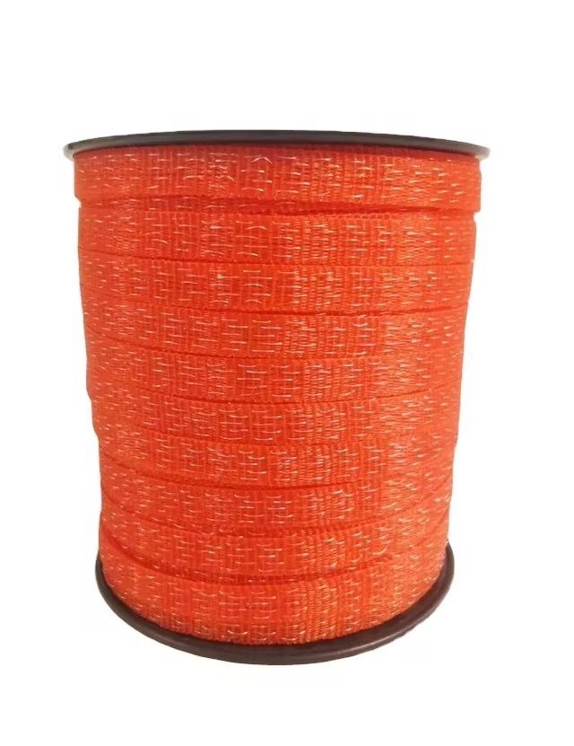 Orange electric-fence polytape on a black plastic reel — high-visibility format for horse and cattle fences