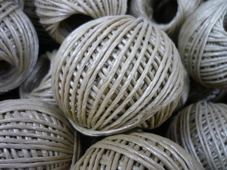 Natural hollow-braided polypropylene rope skein ball, side view
