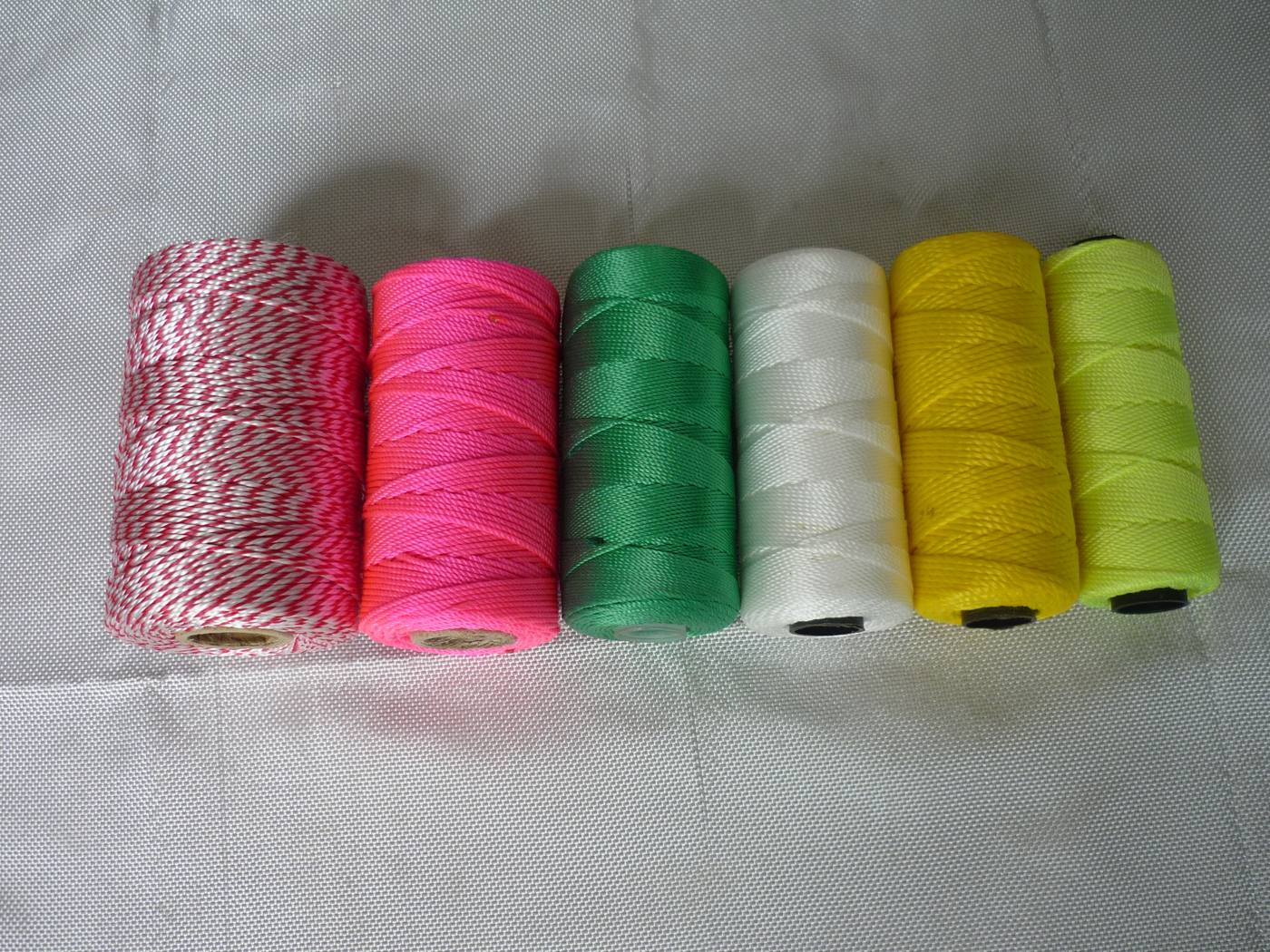 Polypropylene split-film packing twine on small transparent spools, top-down view